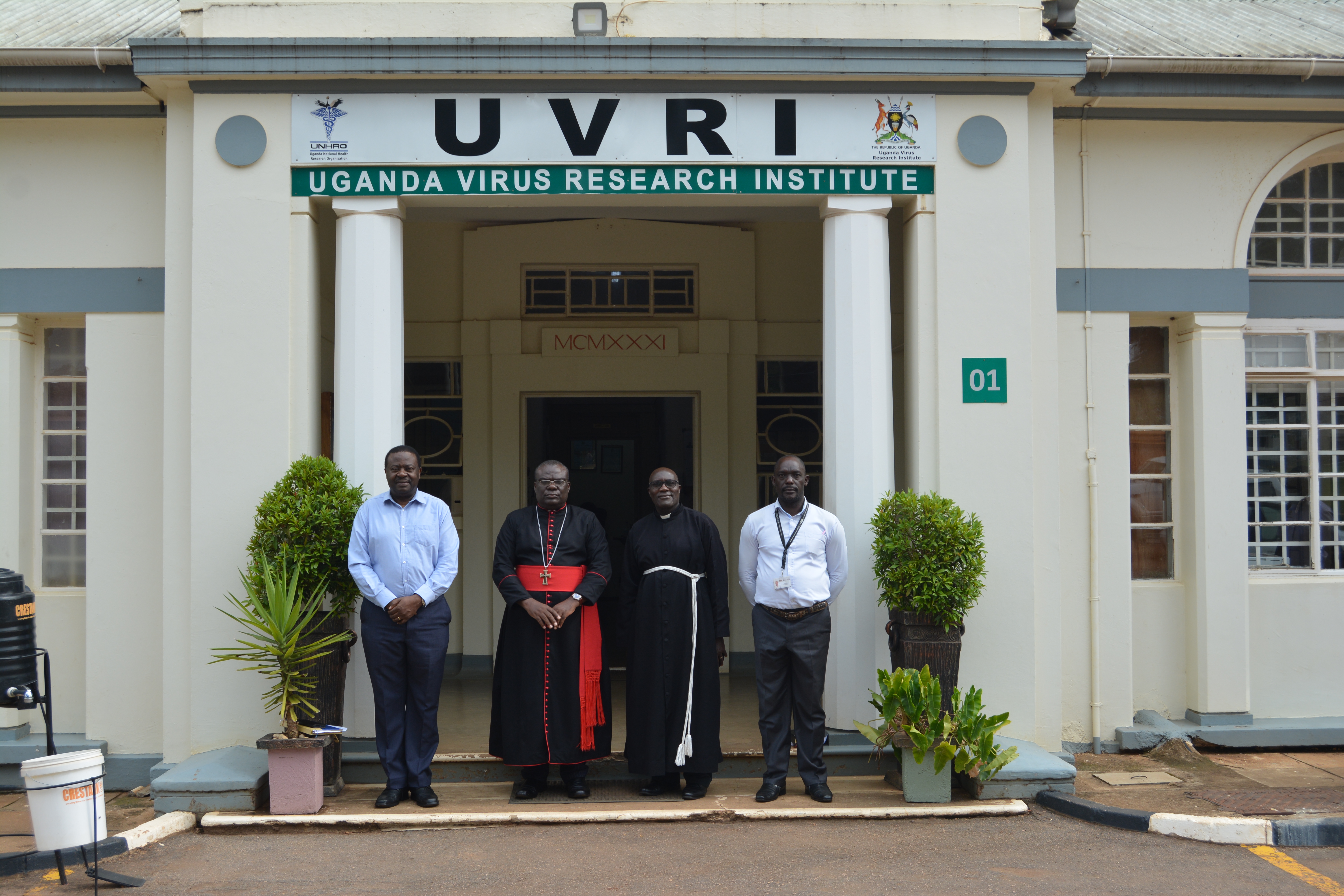 The Archdeacon in a group phot with the director of UVRI